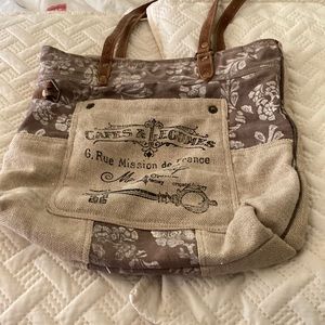 Myra bag, canvass with flower design, leather straps and pulls.